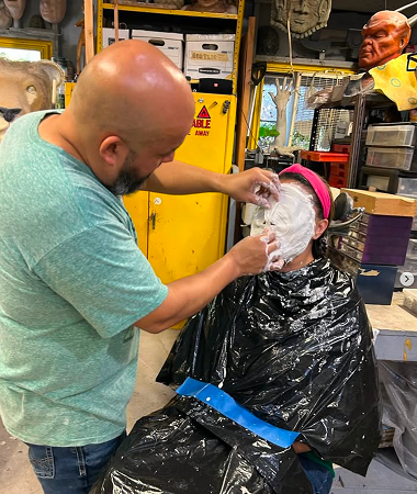Close-up of a student applying prosthetic makeup during Rob Burman's class